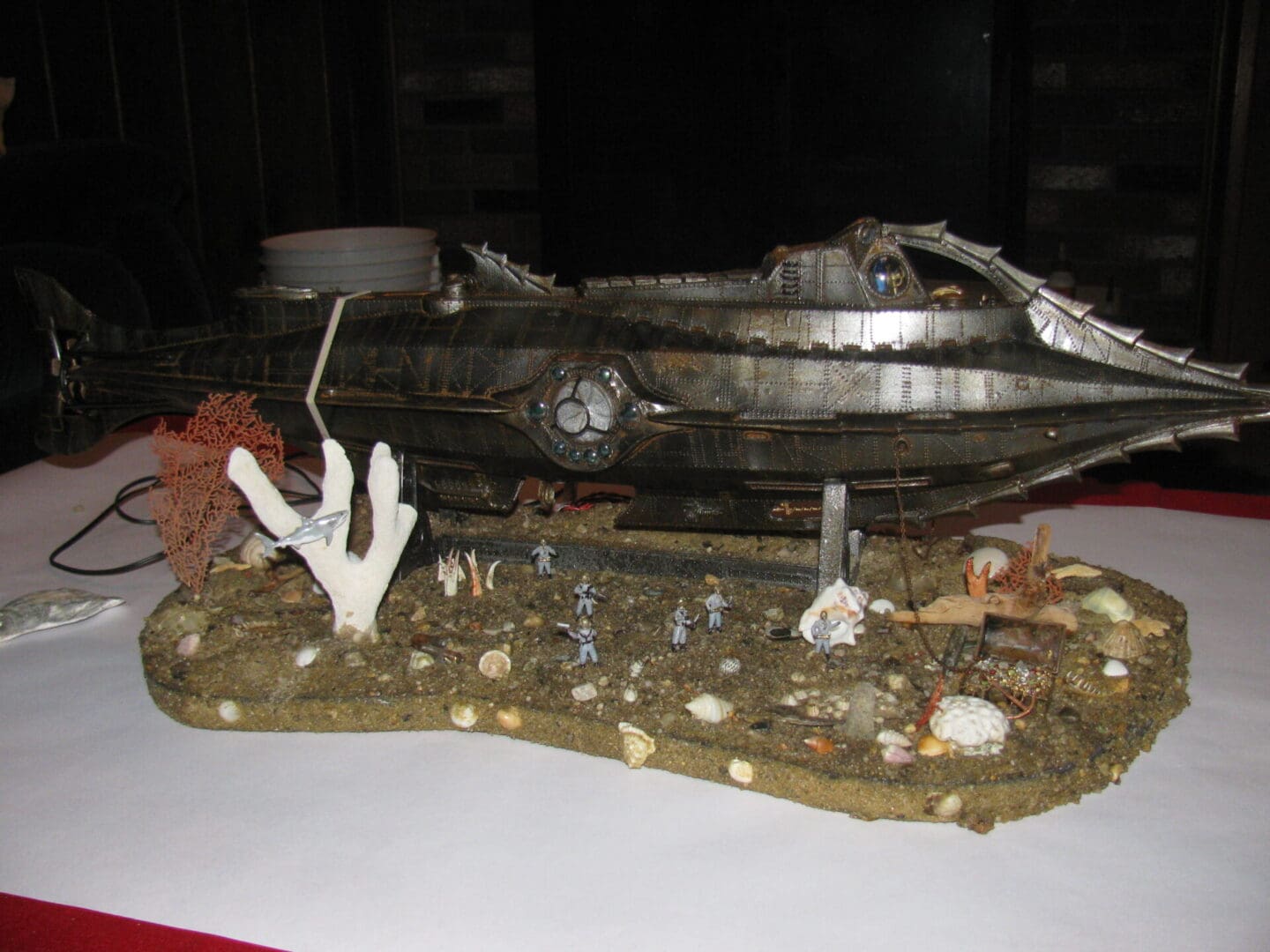 A metal sculpture of an ocean scene on display.