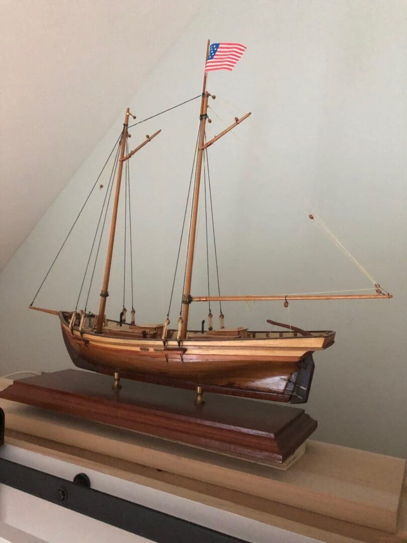 A wooden boat on top of a table.