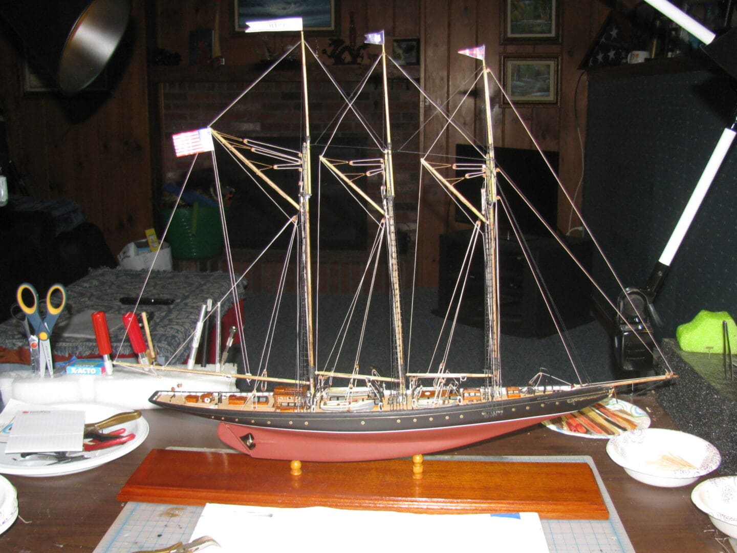 A model of a ship on display in a room.