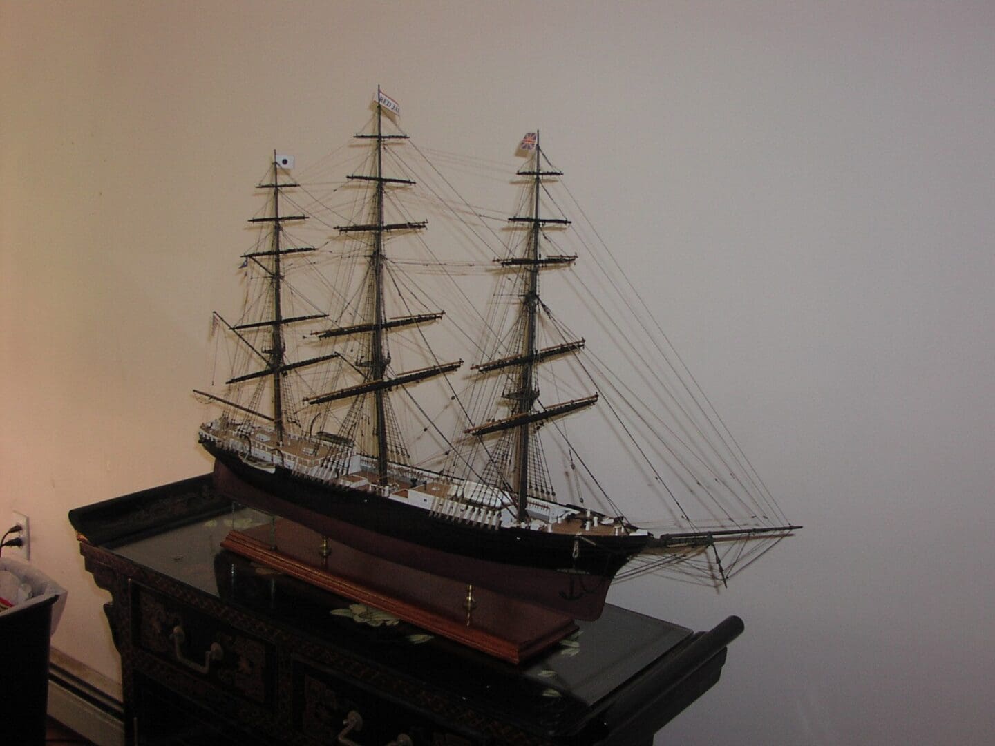 A model of a ship on display in a room.