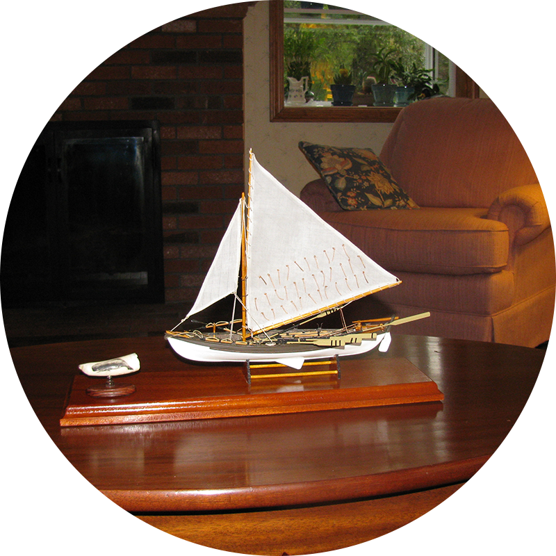 A small model sailboat on top of a table.